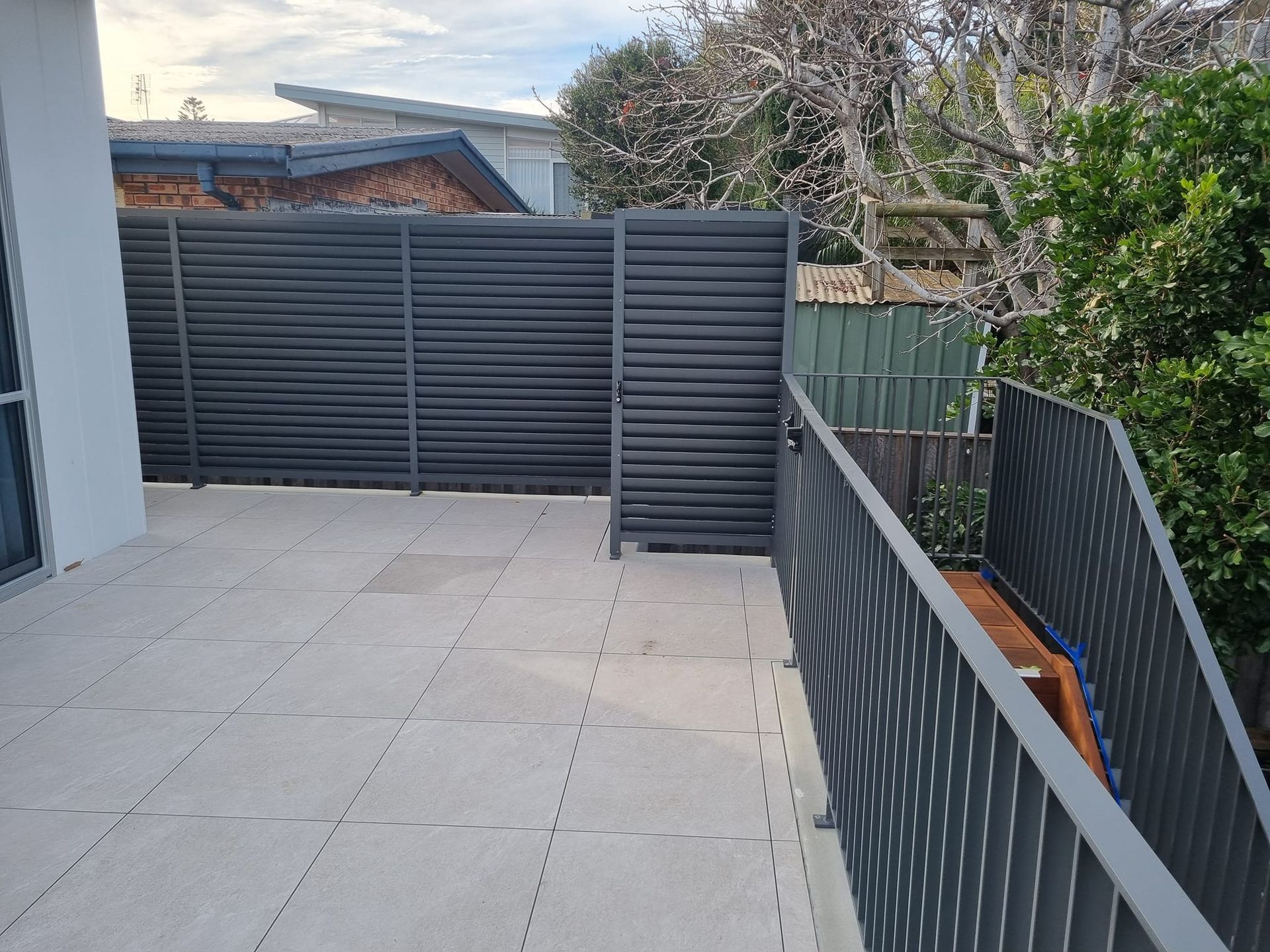 A Balcony With a Fence and Stairs Leading Up to It — D & T Balustrade Systems In Unanderra, NSW