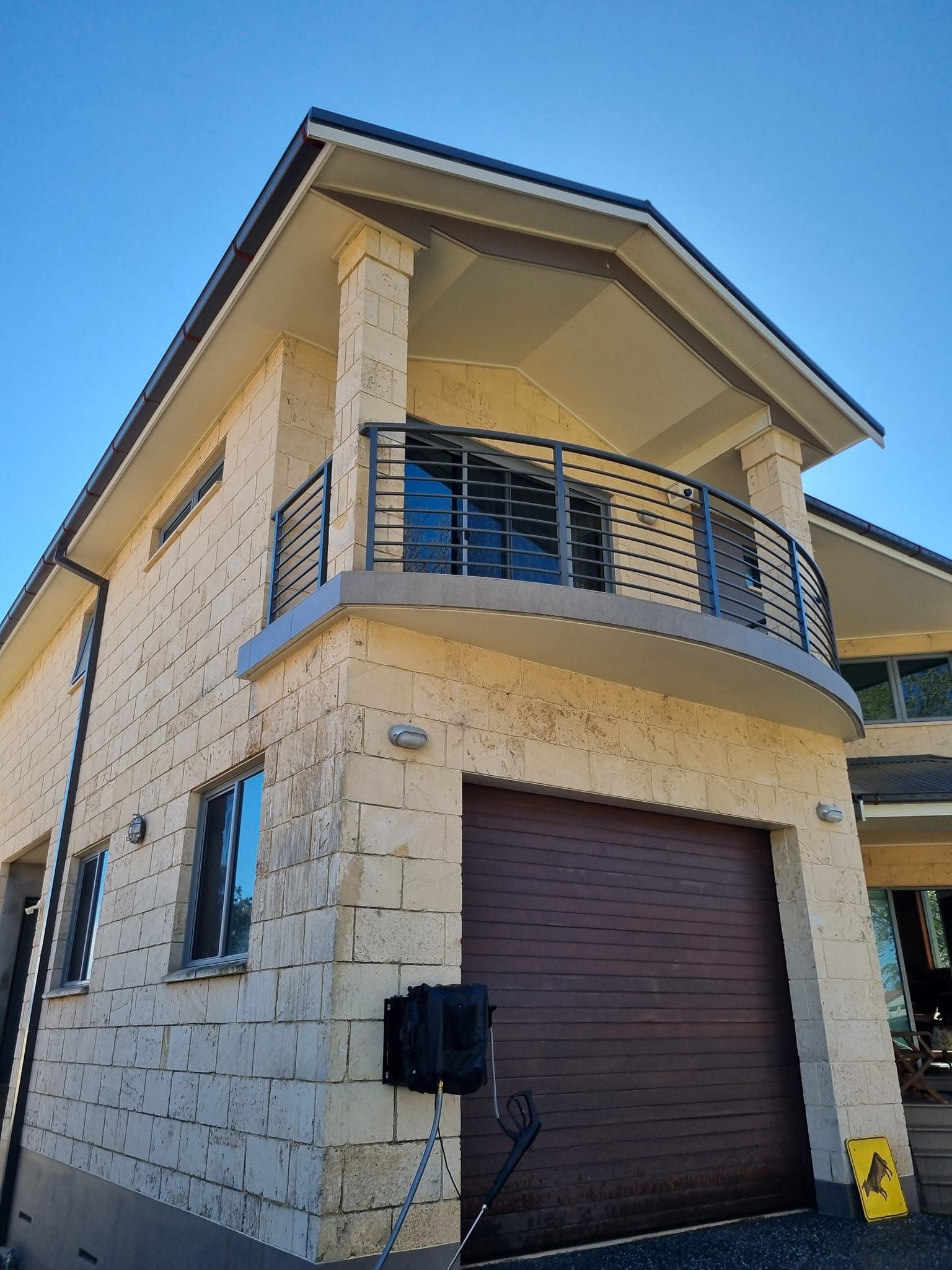 A Large House With a Balcony and a Garage — D & T Balustrade Systems In Unanderra, NSW