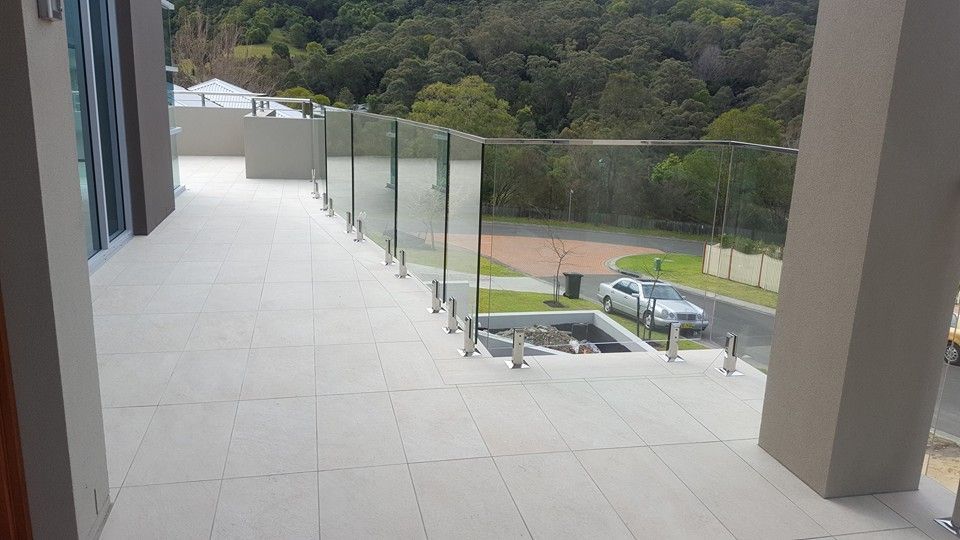 Glass Balustrades on a Balcony overlooking a forest — D & T Balustrade Systems In Unanderra, NSW