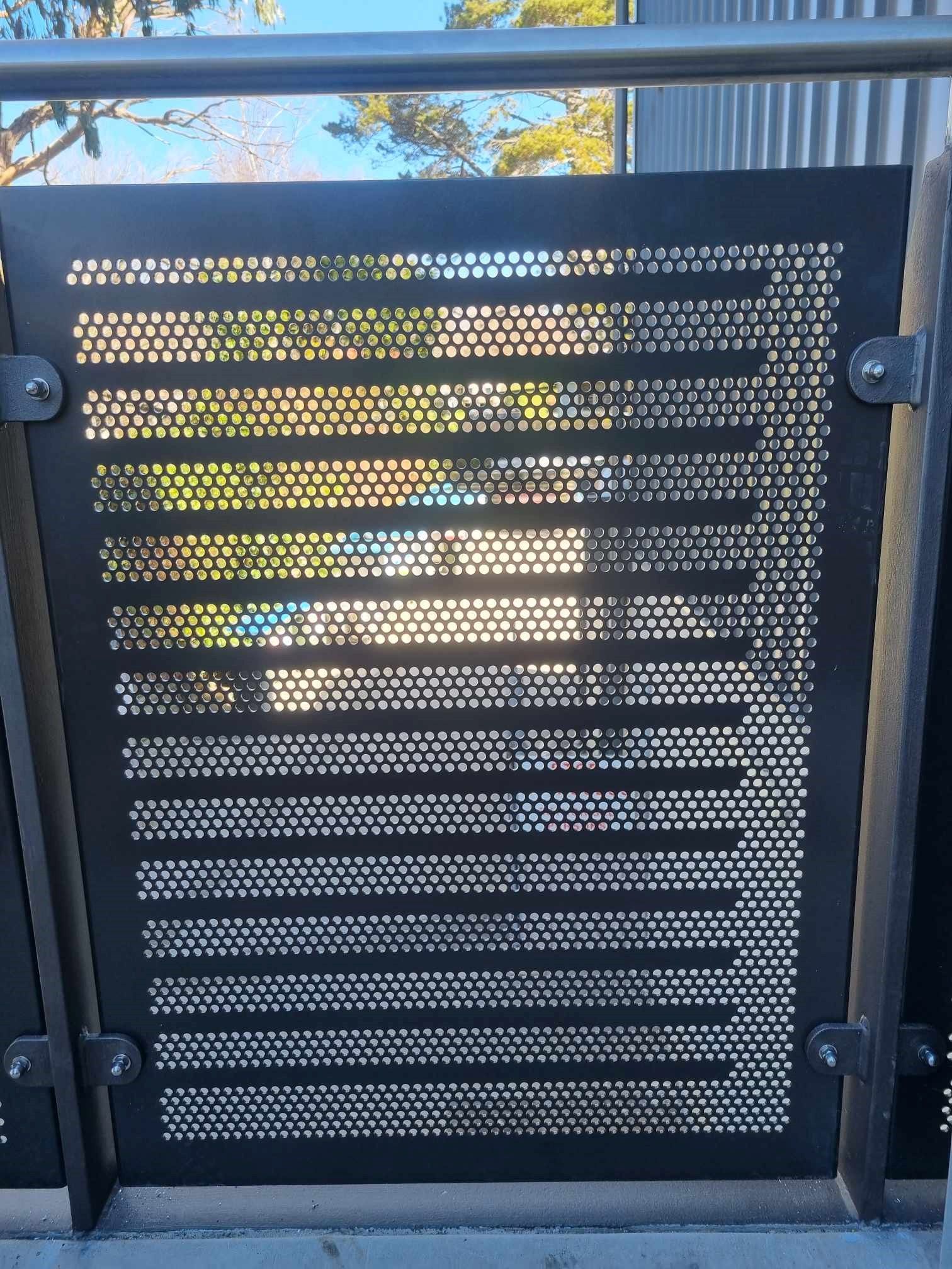 Black metal fence panel with horizontal and dotted perforations — D & T Balustrade Systems In Unanderra, NSW