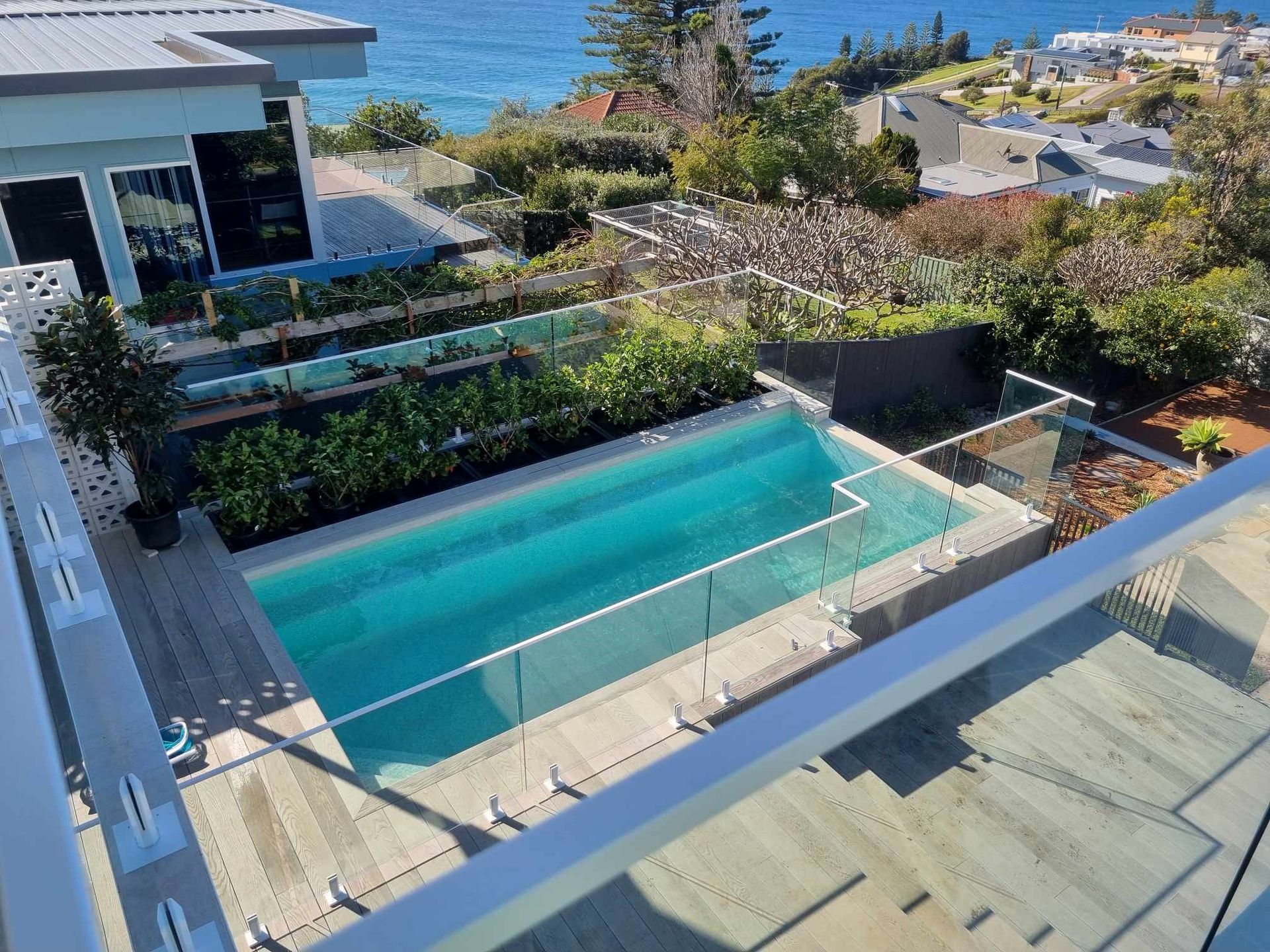 A Modern House With a Swimming Pool — D & T Balustrade Systems In Kiama, NSW