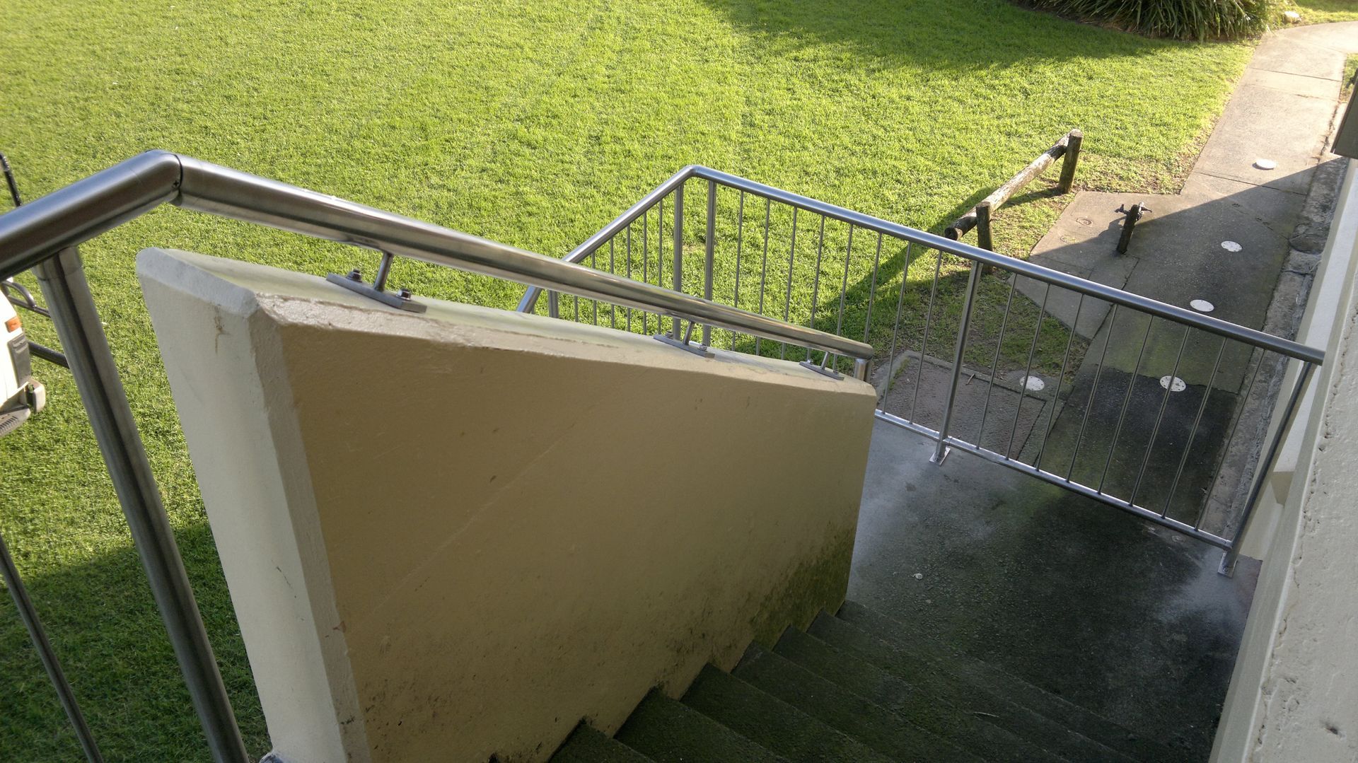 A Set of Stairs Leading Up to a Garage With a Railing — D & T Balustrade Systems In Unanderra, NSW