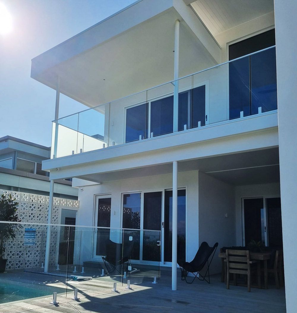 A House With a Pool With Fence — D & T Balustrade Systems In Unanderra, NSW