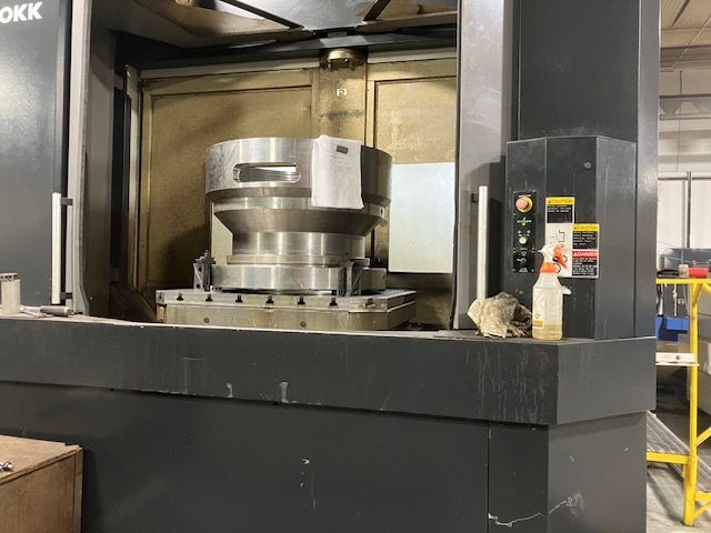 A machine is sitting on top of a table in a factory.