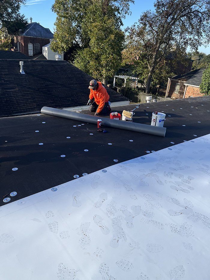 laying out roll before shingling