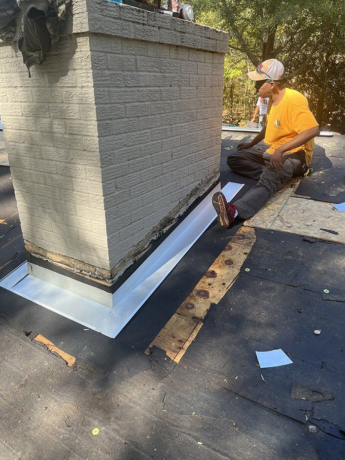 contractor inspecting new waterproofing around chimney