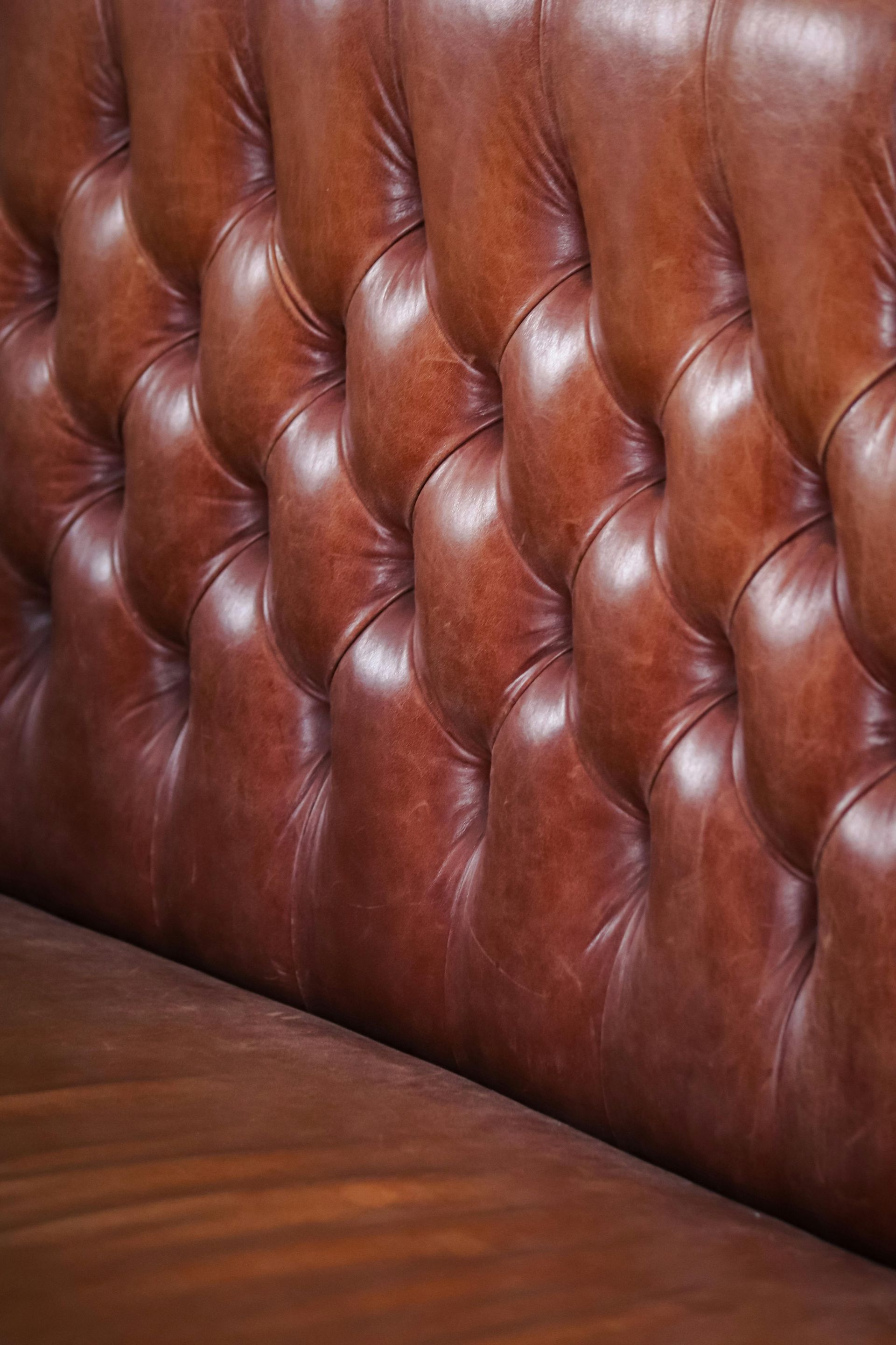 A person is cleaning a window with a mop.
