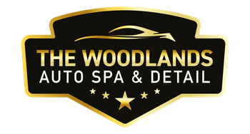 Logo for The Woodlands Auto Spa & Detail, black and gold shield, car silhouette, text, stars.