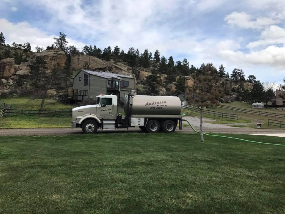 Family gathered at a dining table in a kitchen. They are eating and talking together.