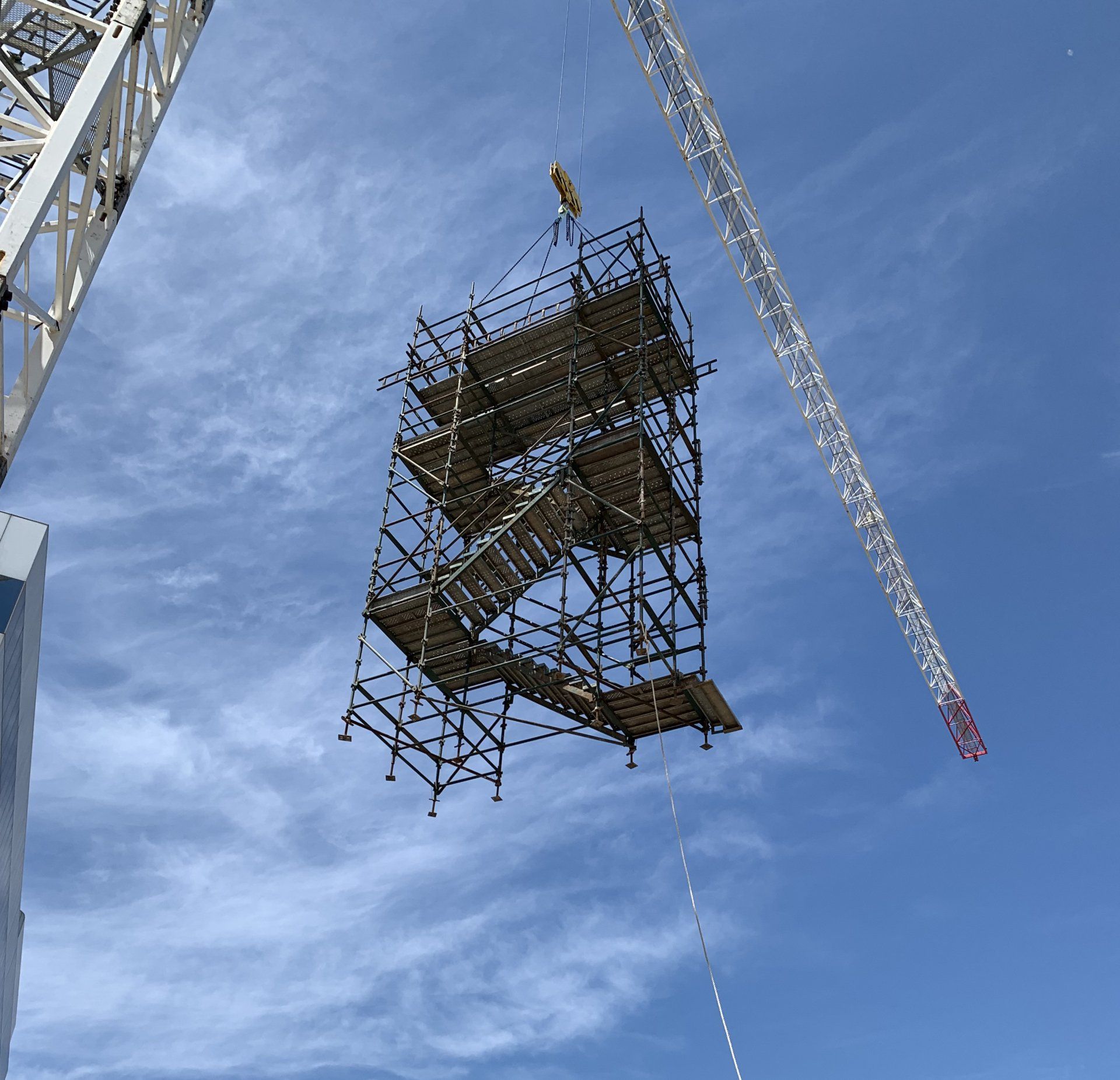 scaffolding being lifted by a crane
