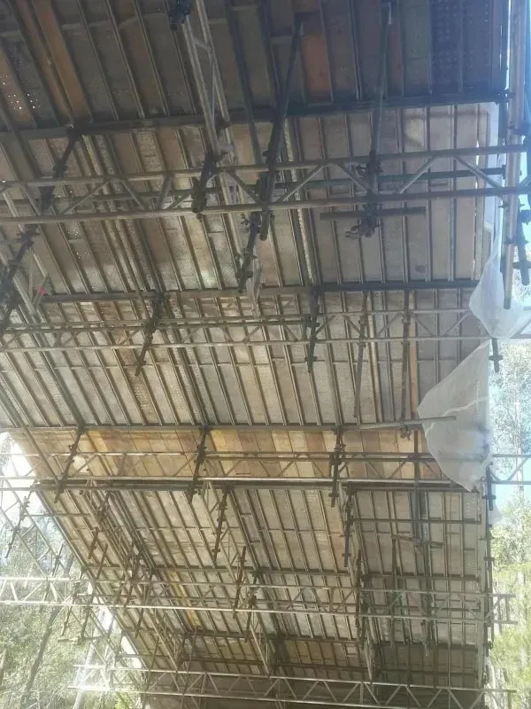 The ceiling of a building is covered in scaffolding.