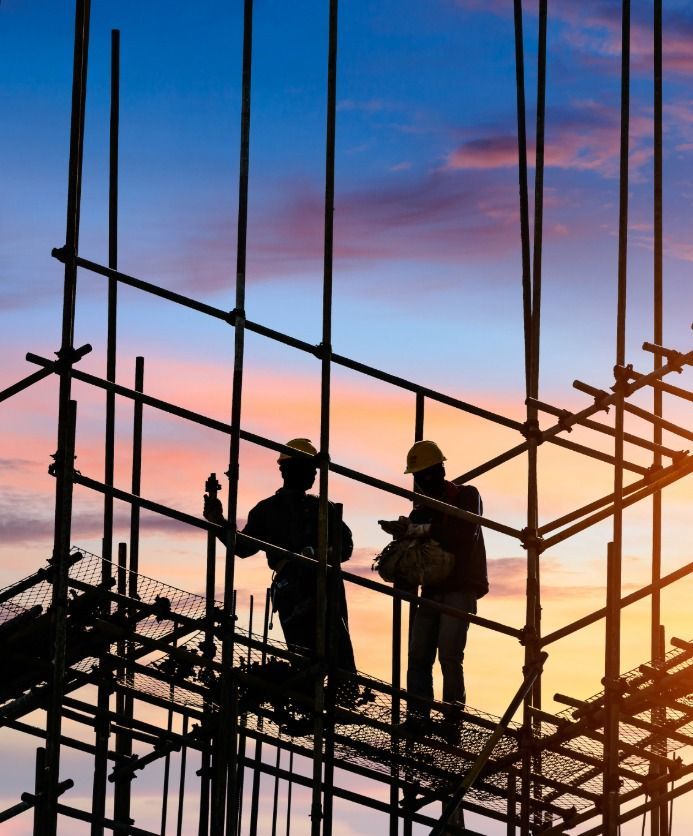 silhouette of a workers standing on the scaffolding
