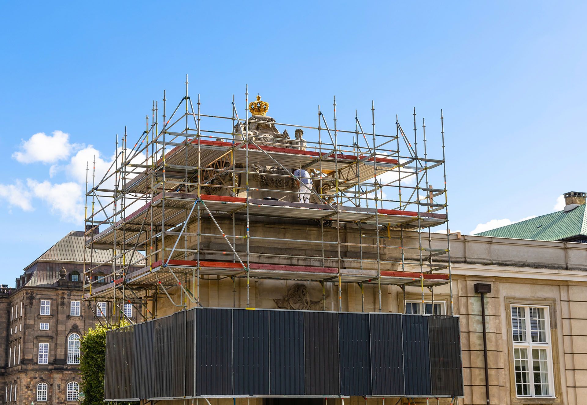 A building is being remodeled with scaffolding on top of it.