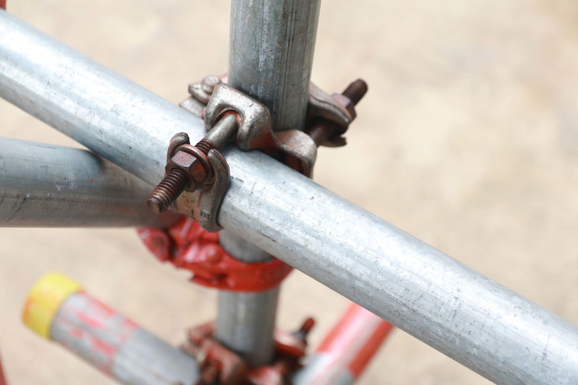 A close up of a metal pipe with a clamp attached to it.