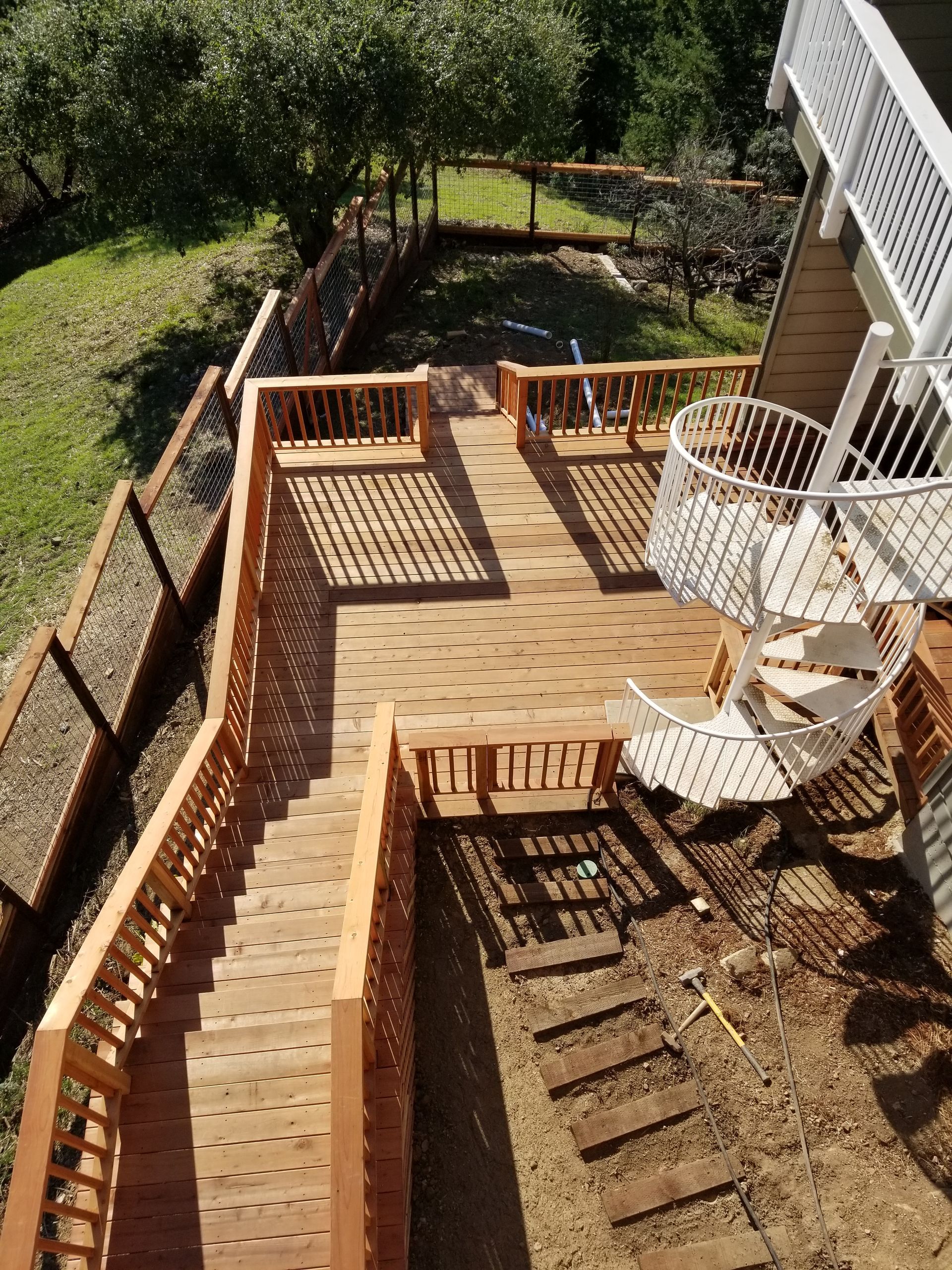 An aerial view of a wooden deck with stairs leading up to it.