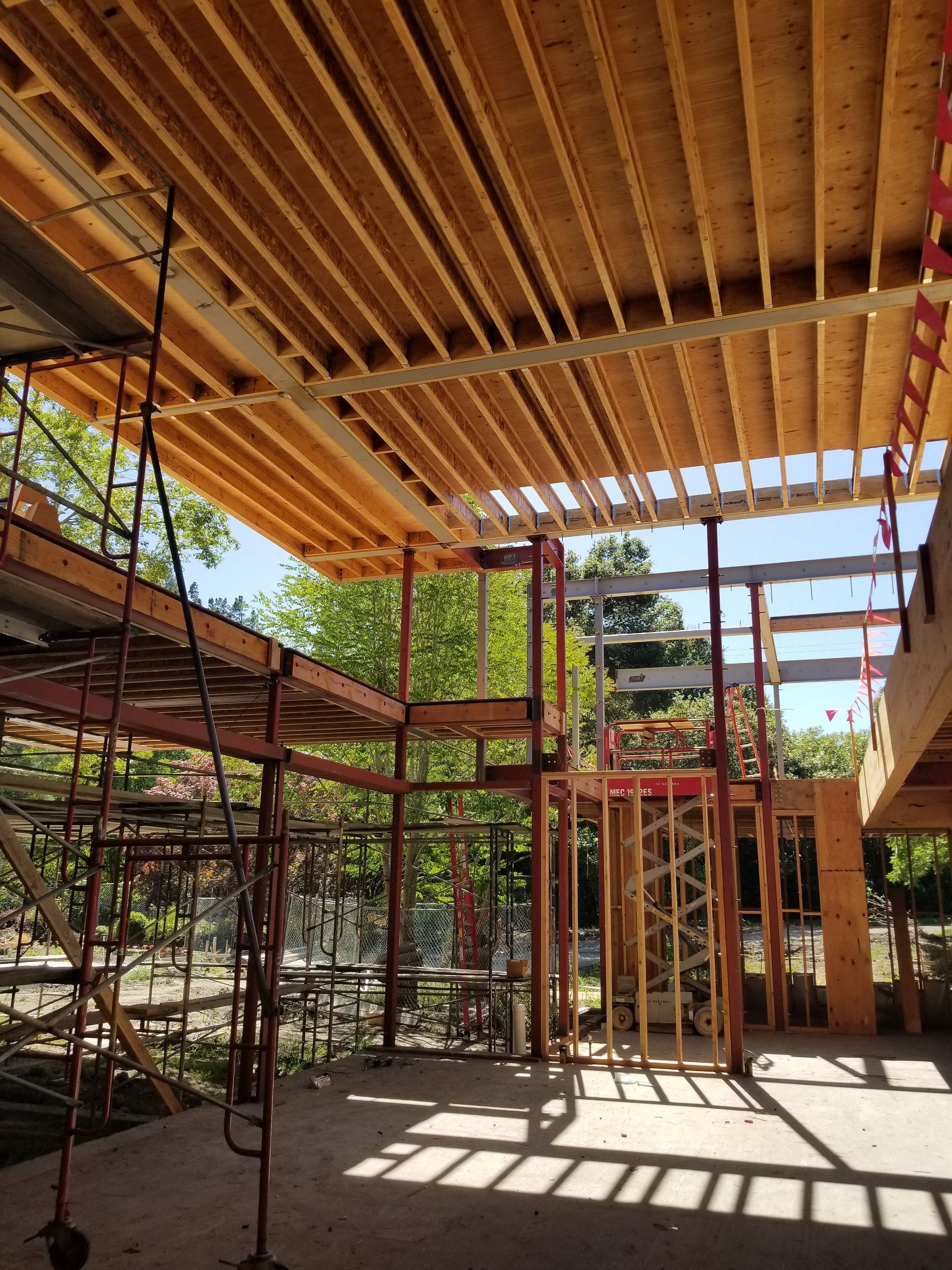 The inside of a building under construction with a wooden ceiling