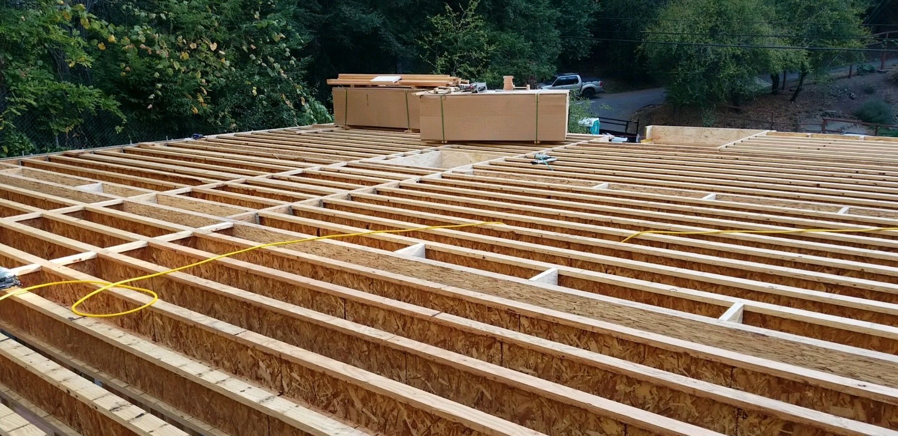 A wooden deck is being built on top of a dirt field.