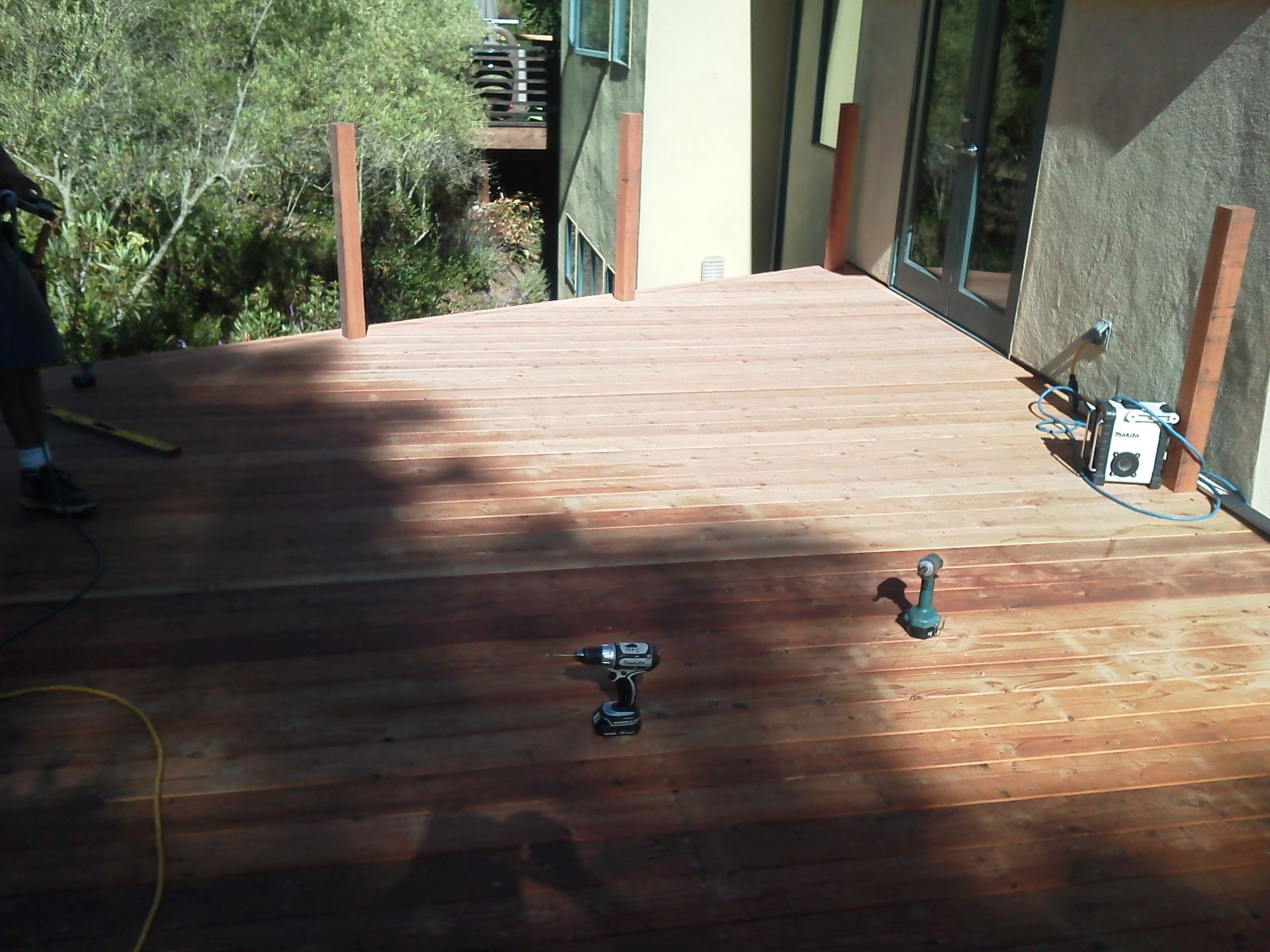 A wooden deck with a drill on it