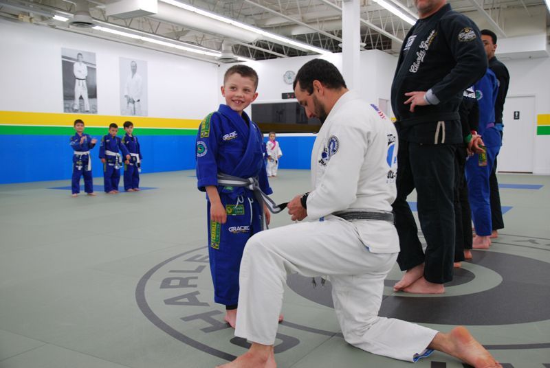 A group of women in karate uniforms are posing for a picture.