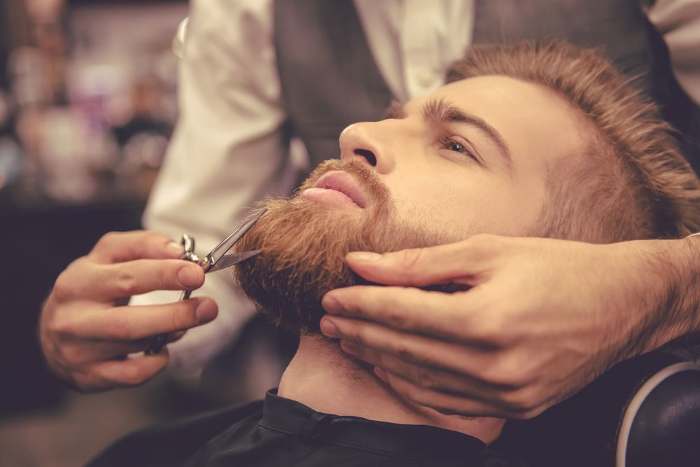 A Male is getting his Beard cut by a hairdresser. — Barbarella Hair in Maryborough, QLD