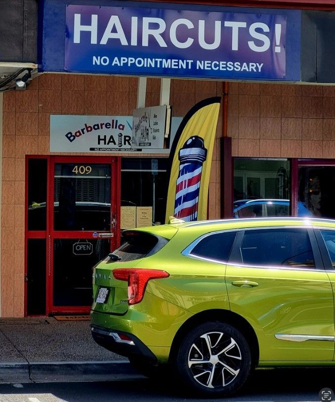 A Green Car is Parked in Front of a Haircut Shop — Barbarella Hair in Maryborough, QLD