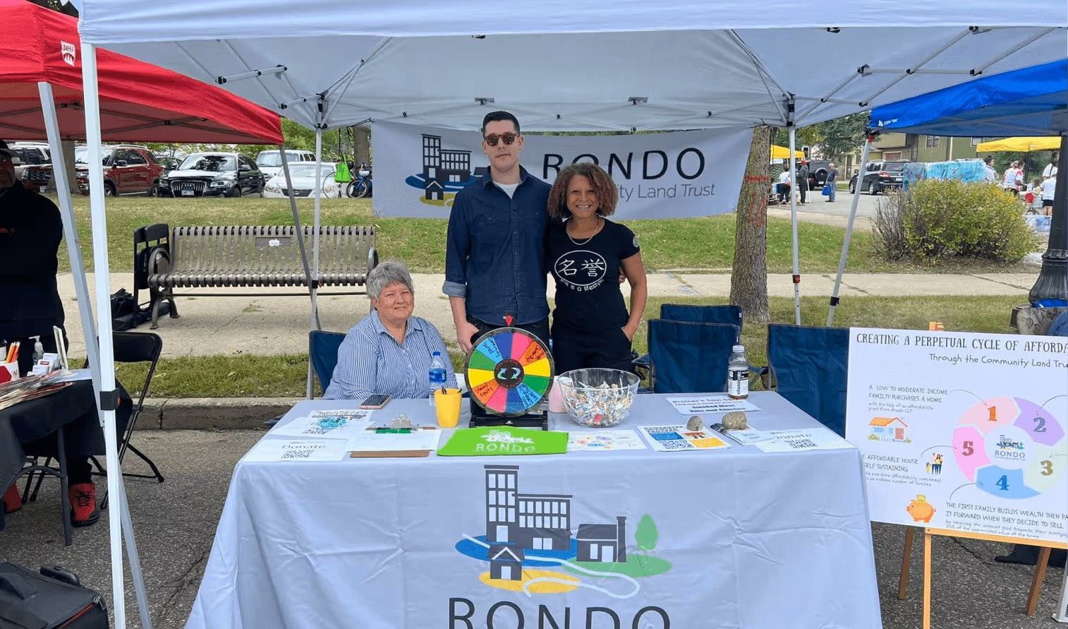 Three people stand behind a 