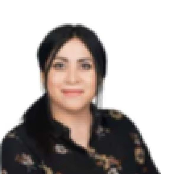 A person with dark hair and a calm expression, wearing a black patterned top against a plain white background.