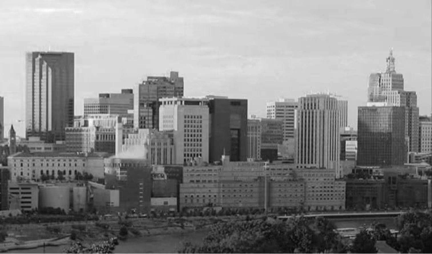 A black and white panoramic view of the Wichita, Kansas city skyline under a clear sky.
