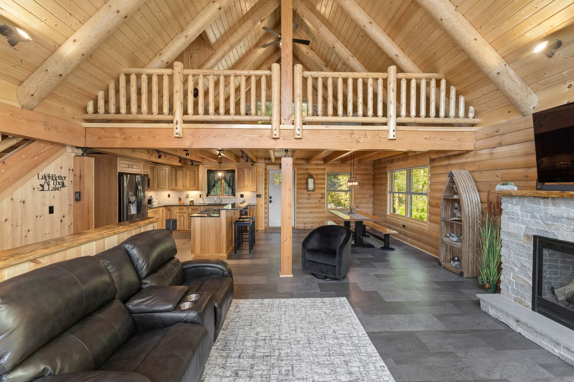 A living room in a log cabin with a couch and a fireplace.