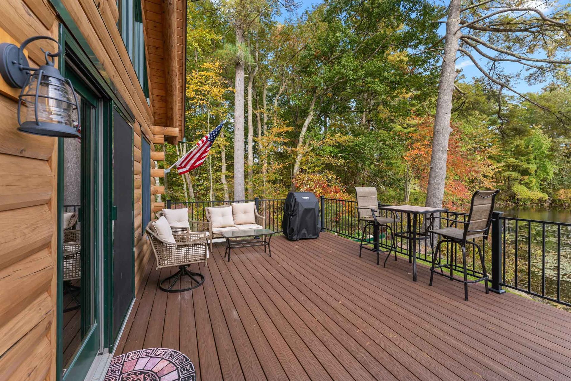 There is a large deck with a table and chairs on it.
