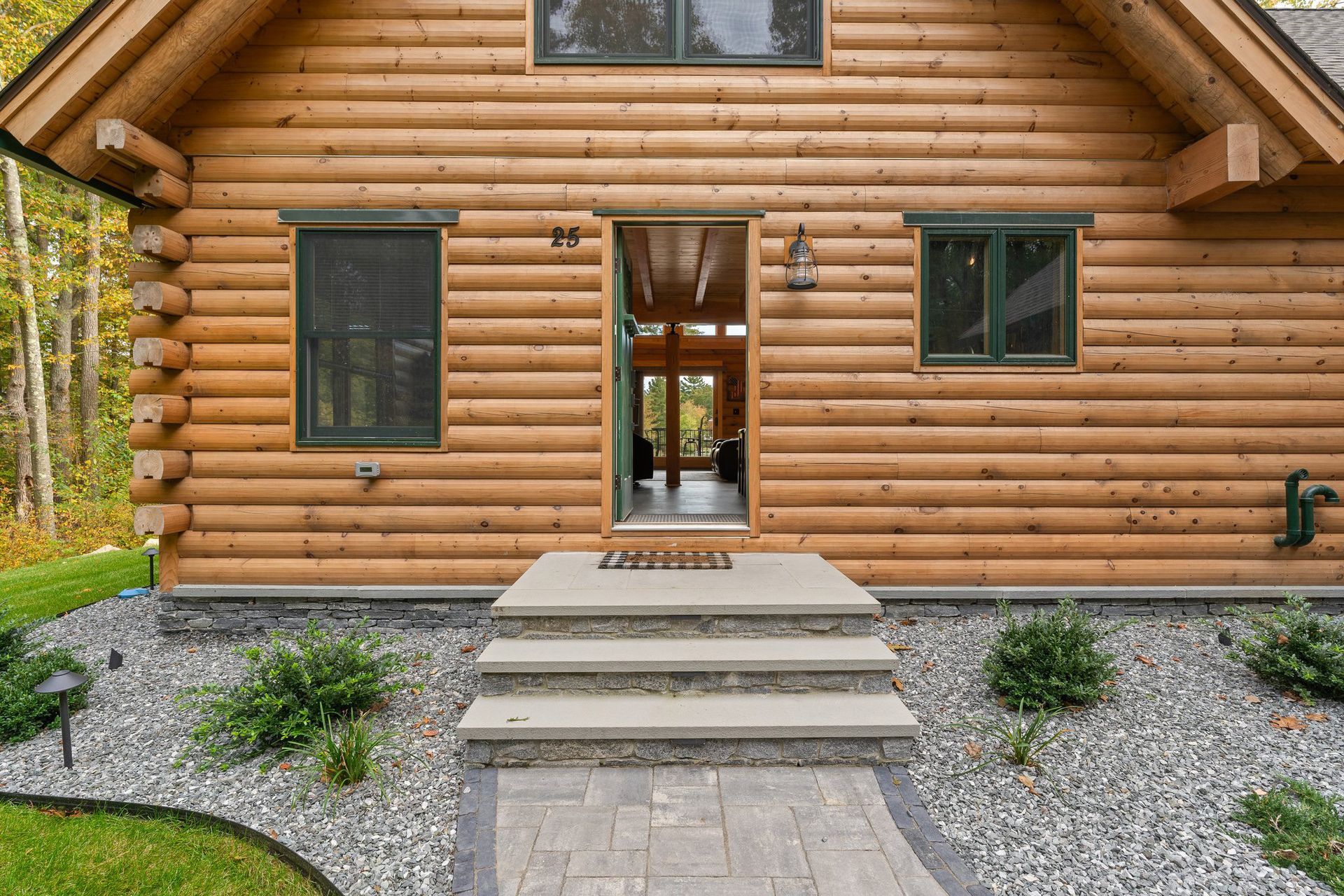 A log cabin with stairs leading up to the front door