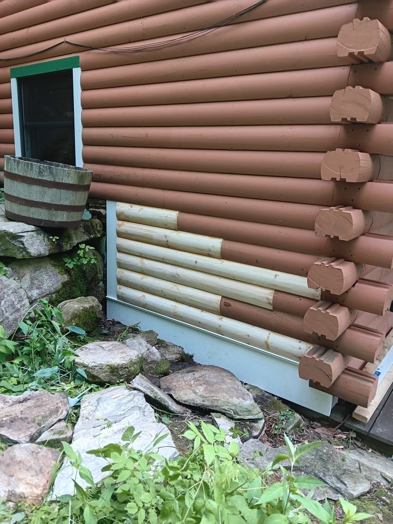 Log Home with a section of exterior wood repaired