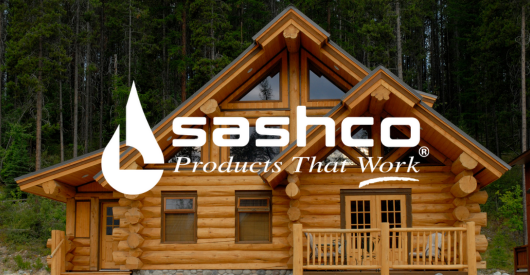A log cabin with the sashco logo on it