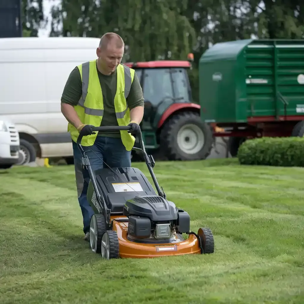 Scenic park with lush greenery and benches, adjacent to a sleek and modern office building.
