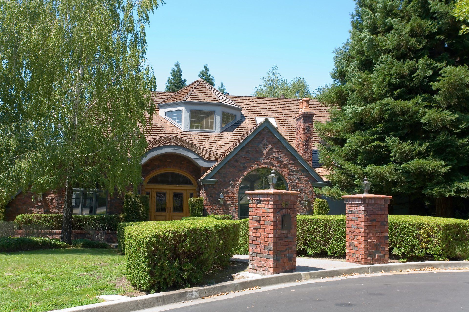 A luxurious brick home with a matching brick mailbox, showcasing timeless elegance and curb appeal.