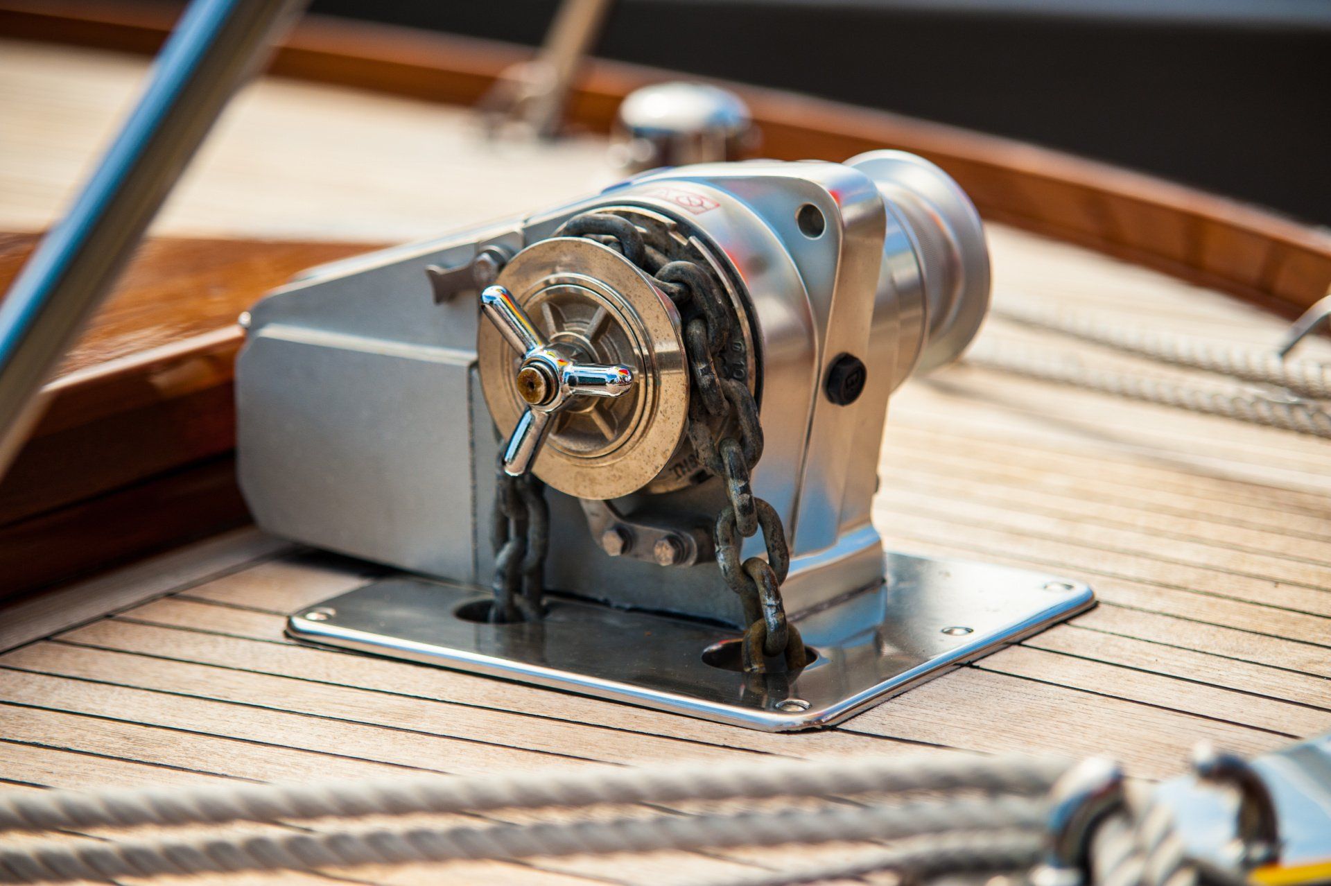 Close-up of the meticulously crafted anchor winch on a handmade wooden boat.