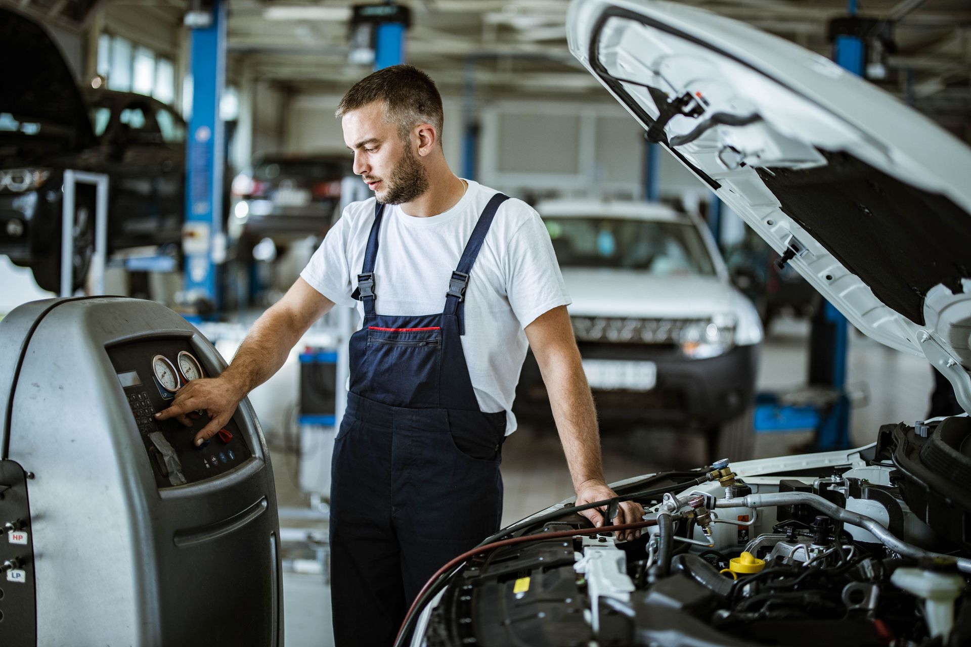 A man is working on a car in a garage.