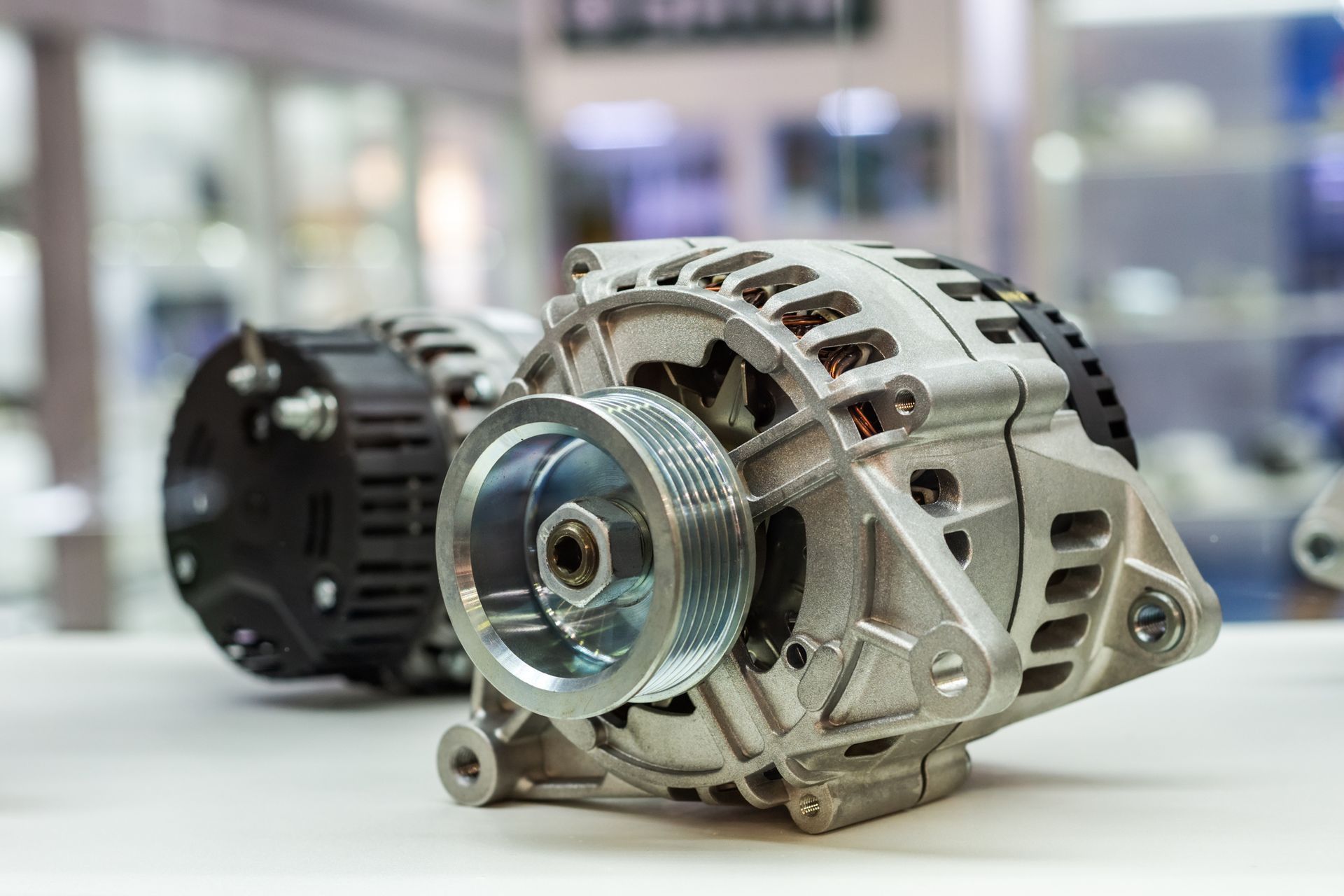 A close up of a car alternator on a table.