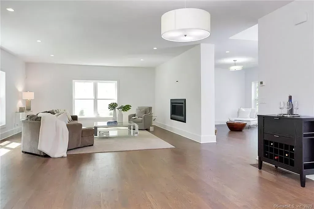 A living room with hardwood floors and white walls
