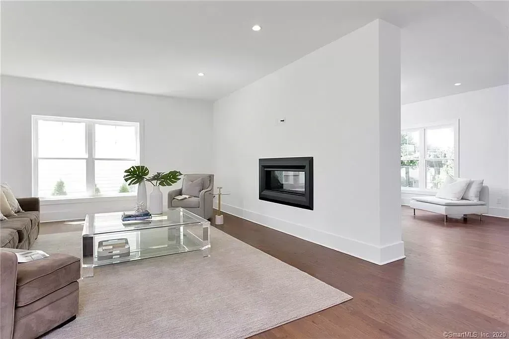 There is a fireplace in the middle of the living room.