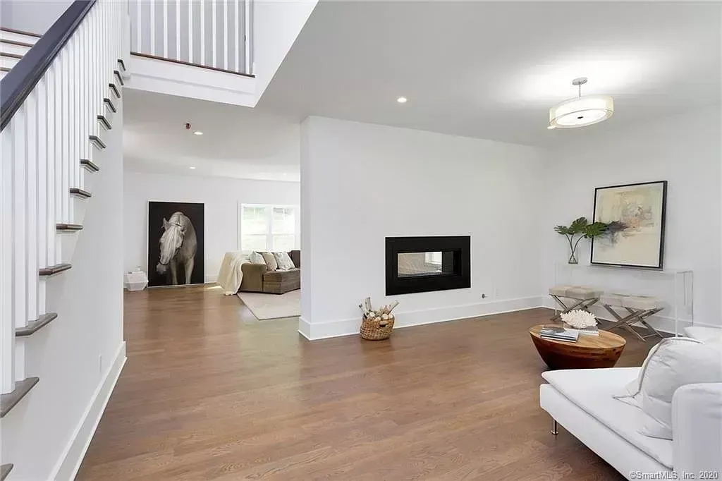 A living room with hardwood floors and a fireplace