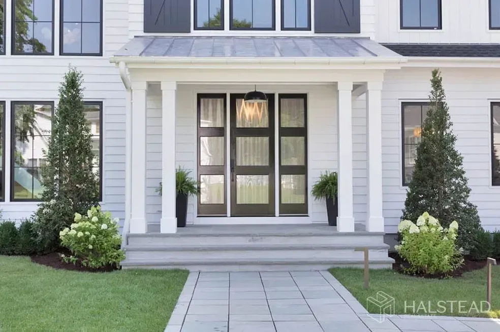 A white house with a black door and black shutters