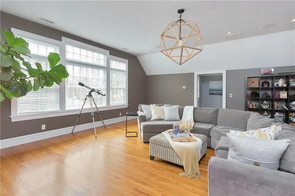 A living room filled with furniture and a telescope.