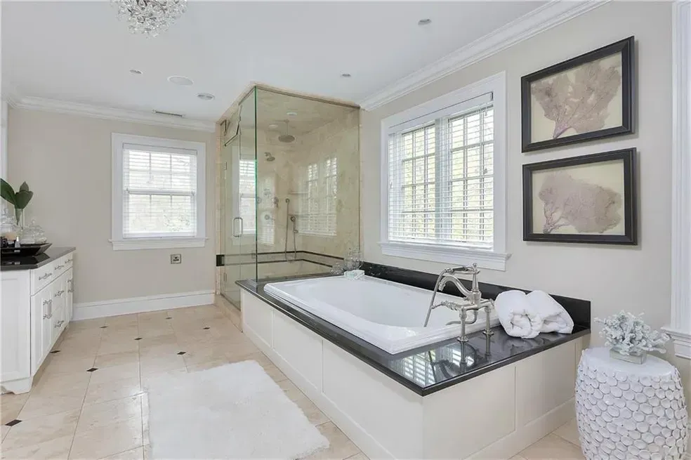 A bathroom with a large tub and a walk in shower.