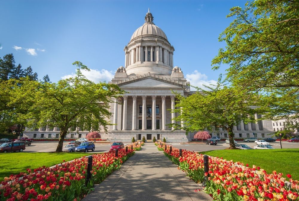 Washington State Capitol building with a path lined with red and orange tulips.