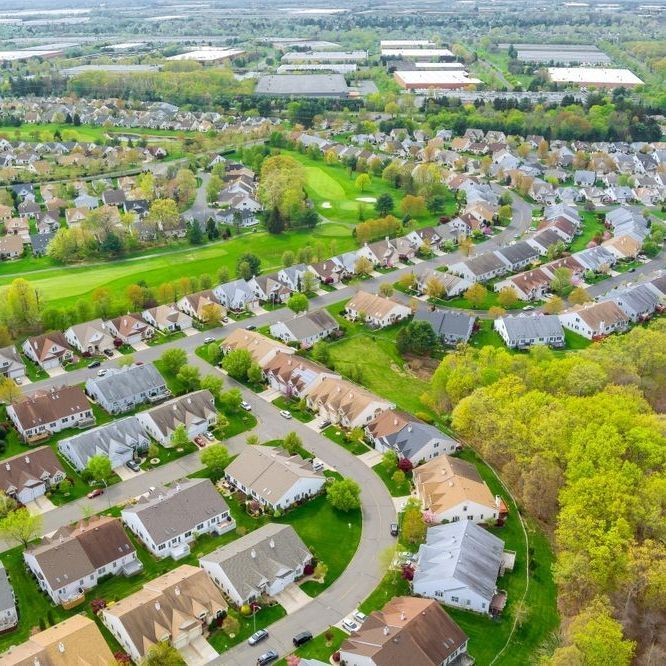 An aerial view of a residential area with lots of houses and trees.