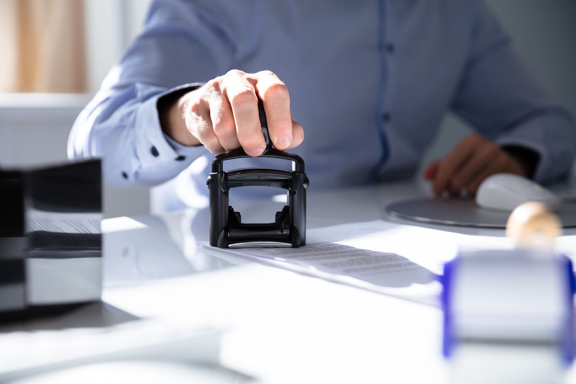 A CRA using a stamp to validate paperwork ensuring data security 