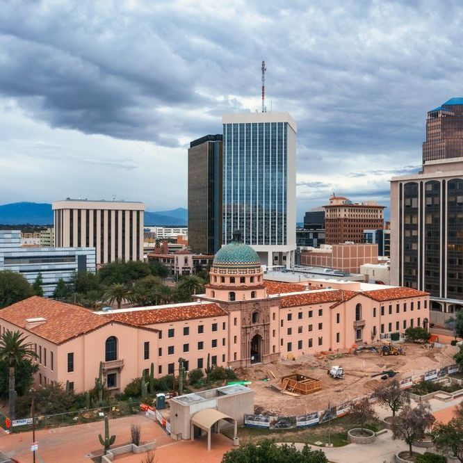 An aerial view of a city with a large building in the foreground