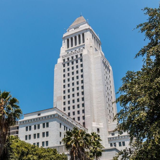 A tall white building with a blue sky in the background