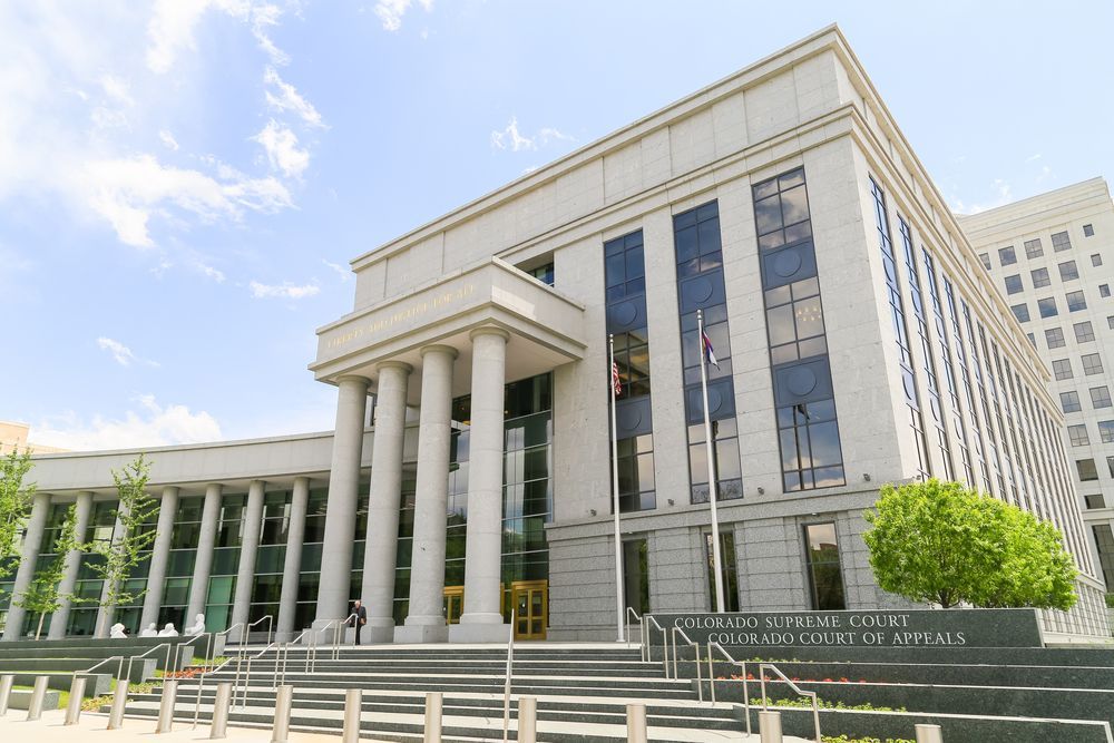 A large building with columns and stairs in front of it.